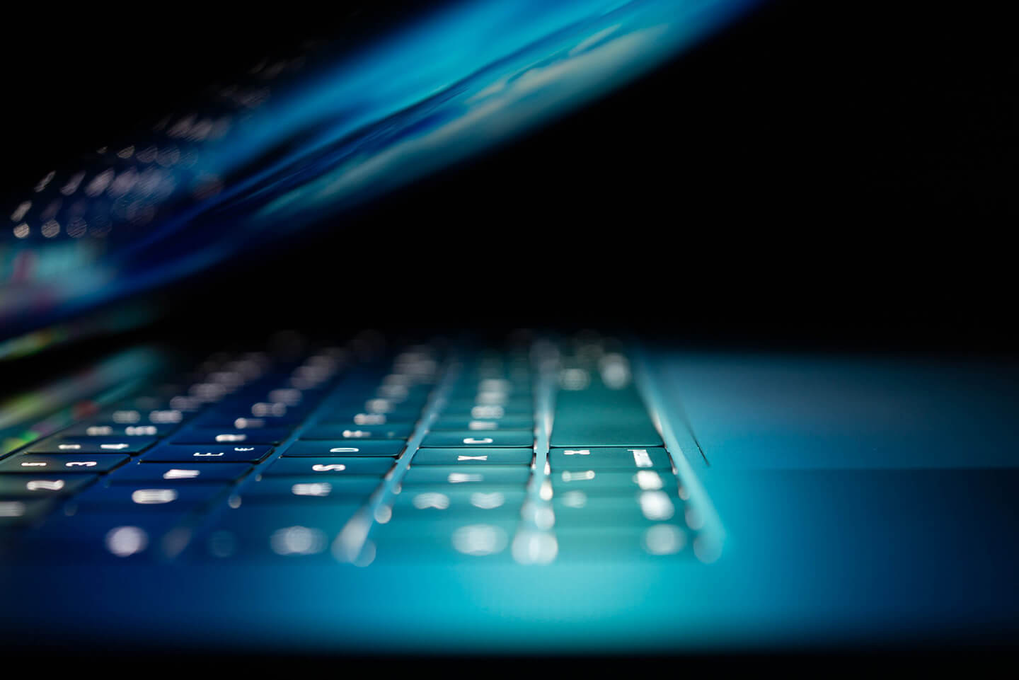 60f4ea713aaff27d8f1d9acd_blockchain-security-banner Article Banner Image - A photo of a laptop halfway closed and in close up